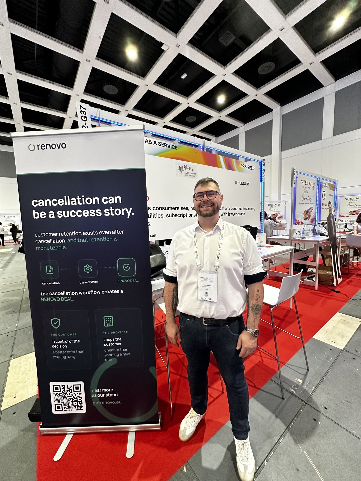 Sándor Molnár, the founder, stands smiling at an exhibition stand at GITEX AI Europe 2026 in Berlin.